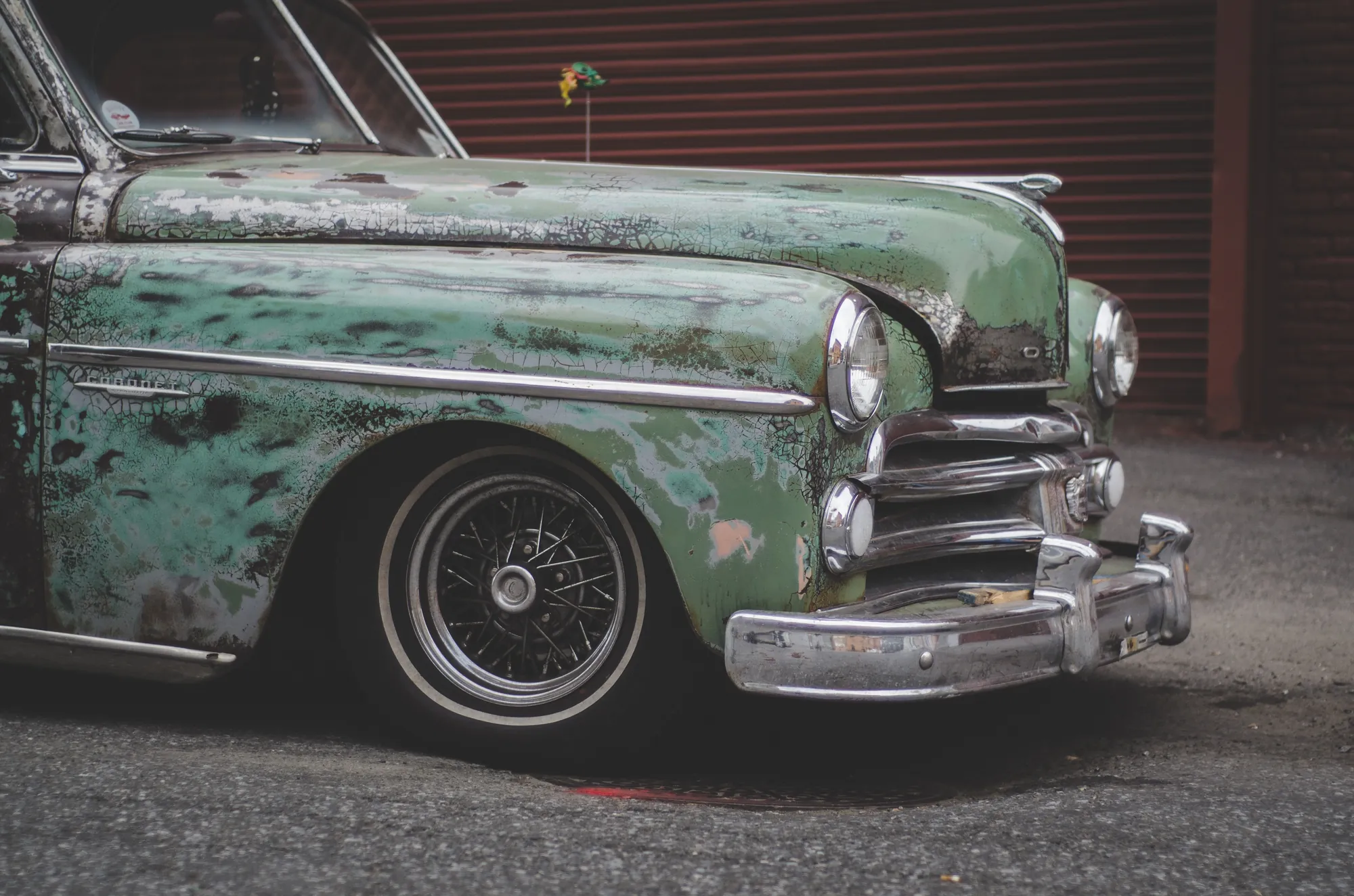 Slammed green Plymouth on wire wheels